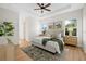 Spacious main bedroom with tray ceiling, ceiling fan, light walls, and two large windows at 4390 Asteria Ter, North Port, FL 34287