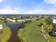Picturesque aerial view of the golf course and community pond enhancing the landscape at 458 Cerromar Rd # 382, Venice, FL 34293