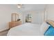 Bright bedroom featuring a sliding glass door, ceiling fan, closet, and a wooden dresser at 458 Cerromar Rd # 382, Venice, FL 34293