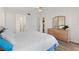 Bright bedroom with a ceiling fan and wooden dresser, providing ample space and natural light at 458 Cerromar Rd # 382, Venice, FL 34293
