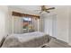 Cozy bedroom with a ceiling fan, sliding glass door to patio, and a spacious closet at 458 Cerromar Rd # 382, Venice, FL 34293