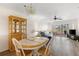 Inviting dining area with a charming china cabinet, chandelier and seamless transition to the living room at 458 Cerromar Rd # 382, Venice, FL 34293