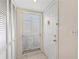 Bright entryway with tile floors, a window with blinds, and a white front door with gold hardware at 458 Cerromar Rd # 382, Venice, FL 34293