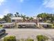 Charming two-story building features covered parking, lush palm trees, and a well-maintained landscape at 458 Cerromar Rd # 382, Venice, FL 34293