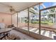 Enclosed lanai featuring a tiled floor and comfortable seating with views of a well-maintained lawn at 458 Cerromar Rd # 382, Venice, FL 34293