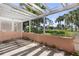 Covered lanai features a concrete floor and peaceful views of the surrounding green spaces and landscaping at 458 Cerromar Rd # 382, Venice, FL 34293