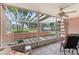 Enclosed lanai offers a relaxing outdoor space with a view of the lush lawn and palm trees at 458 Cerromar Rd # 382, Venice, FL 34293
