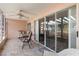 Covered lanai with neutral tile flooring, ceiling fan, and comfortable seating for outdoor relaxation at 458 Cerromar Rd # 382, Venice, FL 34293