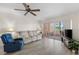 Bright living room features wood flooring, comfortable seating, and a sliding glass door to the lanai at 458 Cerromar Rd # 382, Venice, FL 34293