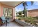 Charming covered patio with tiled flooring and scenic views of lush landscaping and neighborhood at 458 Cerromar Rd # 382, Venice, FL 34293