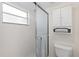 Bright bathroom shower with tiled walls and floor, enclosed by a sliding glass door at 458 Cerromar Rd # 382, Venice, FL 34293