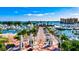 Stunning aerial view of a marina filled with boats, surrounded by lush landscaping, buildings, and clear blue water at 4616 Leeta Ln, Sarasota, FL 34234