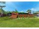 Backyard with green grass, wooden deck, and a swing at 4616 Leeta Ln, Sarasota, FL 34234