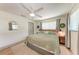Bedroom with natural wood bed frame, hardwood floors, ceiling fan and natural light at 4616 Leeta Ln, Sarasota, FL 34234