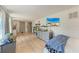 Bedroom with light wood floors, flat screen TV, and large windows at 4616 Leeta Ln, Sarasota, FL 34234