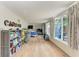 Spacious bedroom with light wood floors and bright window views to the backyard at 4616 Leeta Ln, Sarasota, FL 34234