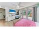 Light-filled bedroom with a television, hardwood floors, and direct access to the backyard at 4616 Leeta Ln, Sarasota, FL 34234