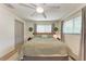 Cozy bedroom with a large bed, ceiling fan, and natural light from the windows at 4616 Leeta Ln, Sarasota, FL 34234