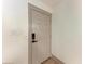 Modern entryway features a gray door with smart lock and minimalist trim, creating a sleek and secure entrance at 4616 Leeta Ln, Sarasota, FL 34234