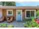 Cozy front porch with chairs and a blue door adorned with a wreath, showcasing an inviting entryway at 4616 Leeta Ln, Sarasota, FL 34234