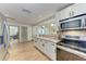 Modern kitchen with granite counters, stainless steel appliances, and views to the dining area at 4616 Leeta Ln, Sarasota, FL 34234