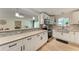 Updated kitchen showcasing stainless steel appliances, granite counters, subway tile backsplash and modern fixtures at 4616 Leeta Ln, Sarasota, FL 34234
