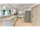 Bright kitchen with white cabinets, stainless steel appliances, granite countertops, and wood floors at 4616 Leeta Ln, Sarasota, FL 34234