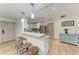 Open kitchen featuring a breakfast bar with pendant lighting, stainless steel appliances and wooden floors at 4616 Leeta Ln, Sarasota, FL 34234