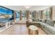 Bright and sunny living room with large windows, a comfortable couch, and modern decor at 4616 Leeta Ln, Sarasota, FL 34234
