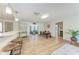Bright and airy living space open to the dining area and kitchen, featuring updated flooring and neutral decor at 4616 Leeta Ln, Sarasota, FL 34234