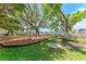 A Gathering friendly playground area and grassy picnic spot overlook waterfront homes under a bright blue sky at 4616 Leeta Ln, Sarasota, FL 34234