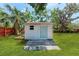 Backyard shed with a blue door, green grass, and a small window at 4616 Leeta Ln, Sarasota, FL 34234