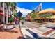 Vibrant street view with colorful buildings, palm trees, outdoor seating, and inviting storefronts on a clear day at 4616 Leeta Ln, Sarasota, FL 34234