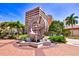 Street view showcasing a modern sculpture with water feature, surrounded by palm trees and commercial buildings at 4616 Leeta Ln, Sarasota, FL 34234
