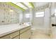 Cozy bathroom features bright yellow floral wallpaper and a tub/shower combination at 465 Laurencin Dr, Nokomis, FL 34275