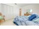 Bedroom with comfortable bed, view through to entry, and large closet at 465 Laurencin Dr, Nokomis, FL 34275