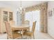 Elegant dining room with chandelier, decorative window valance, and classic furniture at 465 Laurencin Dr, Nokomis, FL 34275