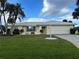 Well-maintained single story home featuring a 2 car garage, meticulous landscaping, and an idyllic garden at 465 Laurencin Dr, Nokomis, FL 34275