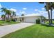 Inviting single-story home with a two-car garage, immaculate landscaping, and a well-kept front yard at 465 Laurencin Dr, Nokomis, FL 34275