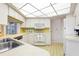 Functional kitchen with white appliances, stylish countertops, and convenient pass-through to other living space at 465 Laurencin Dr, Nokomis, FL 34275