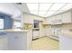 Well-lit kitchen featuring a pass-through window, white cabinets, and modern appliances at 465 Laurencin Dr, Nokomis, FL 34275