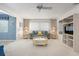 Comfortable living room featuring plush carpeting, built-in shelving, and natural lighting at 465 Laurencin Dr, Nokomis, FL 34275