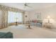 Bright living room featuring floral sofa, glass table, and custom window treatments at 465 Laurencin Dr, Nokomis, FL 34275