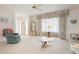 Bright living room with floral sofa, a glass coffee table, and custom window treatments at 465 Laurencin Dr, Nokomis, FL 34275