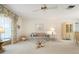 Cozy living room featuring a floral sofa, glass top table, and custom window treatments at 465 Laurencin Dr, Nokomis, FL 34275