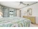 Bright bedroom with floral decor, dresser, and view of outdoor pool at 465 Laurencin Dr, Nokomis, FL 34275
