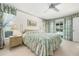 Bedroom features floral bedding, side tables with lamps, and view to outdoors at 465 Laurencin Dr, Nokomis, FL 34275