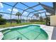 Enclosed pool with a clear view of the sky and backyard landscaping at 465 Laurencin Dr, Nokomis, FL 34275