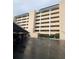 Exterior shot of the condo building with parking, showing architectural style and accessibility at 512 W Venice Ave # 205, Venice, FL 34285