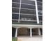 Entrance to a building that has benches and a covered area and dark tinted windows at 512 W Venice Ave # 205, Venice, FL 34285